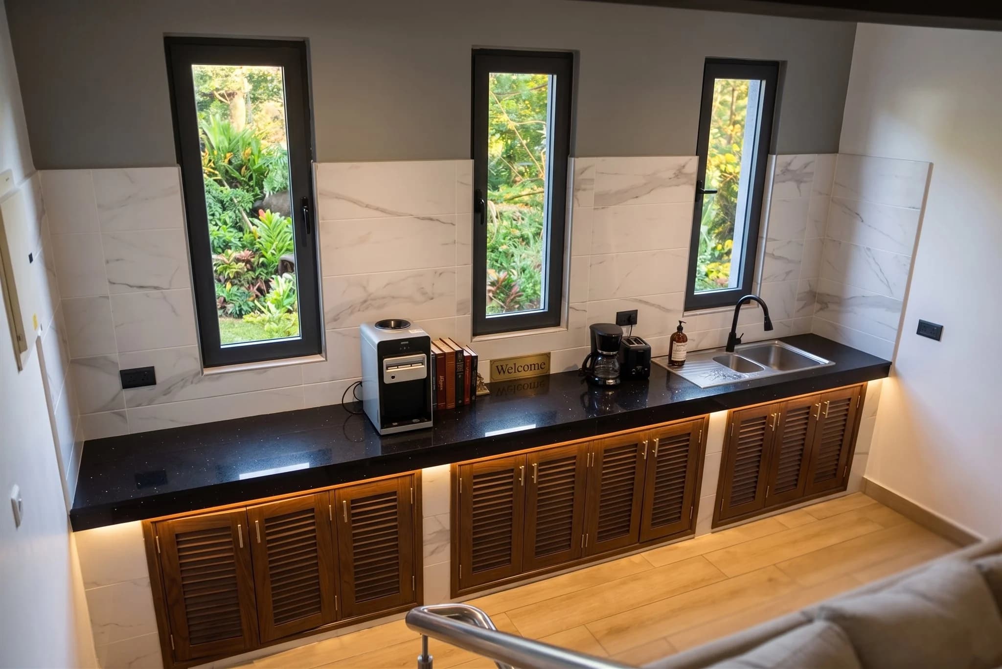 Modern island bar and refreshment counter adjacent to the first floor living room at The Coastal Estate