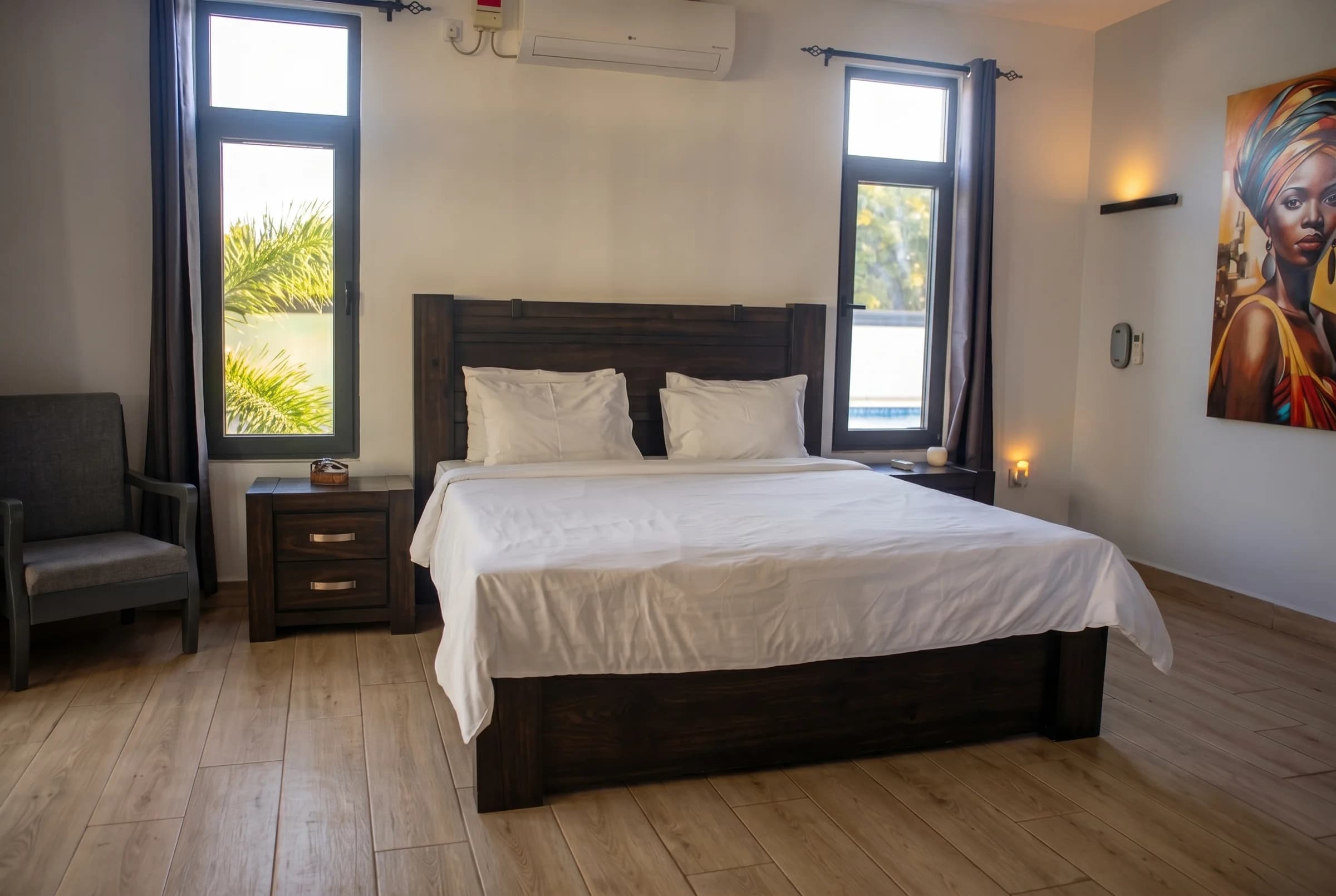 Executive master bedroom suite on the first floor with king bed, air conditioning, and fine coastal textiles