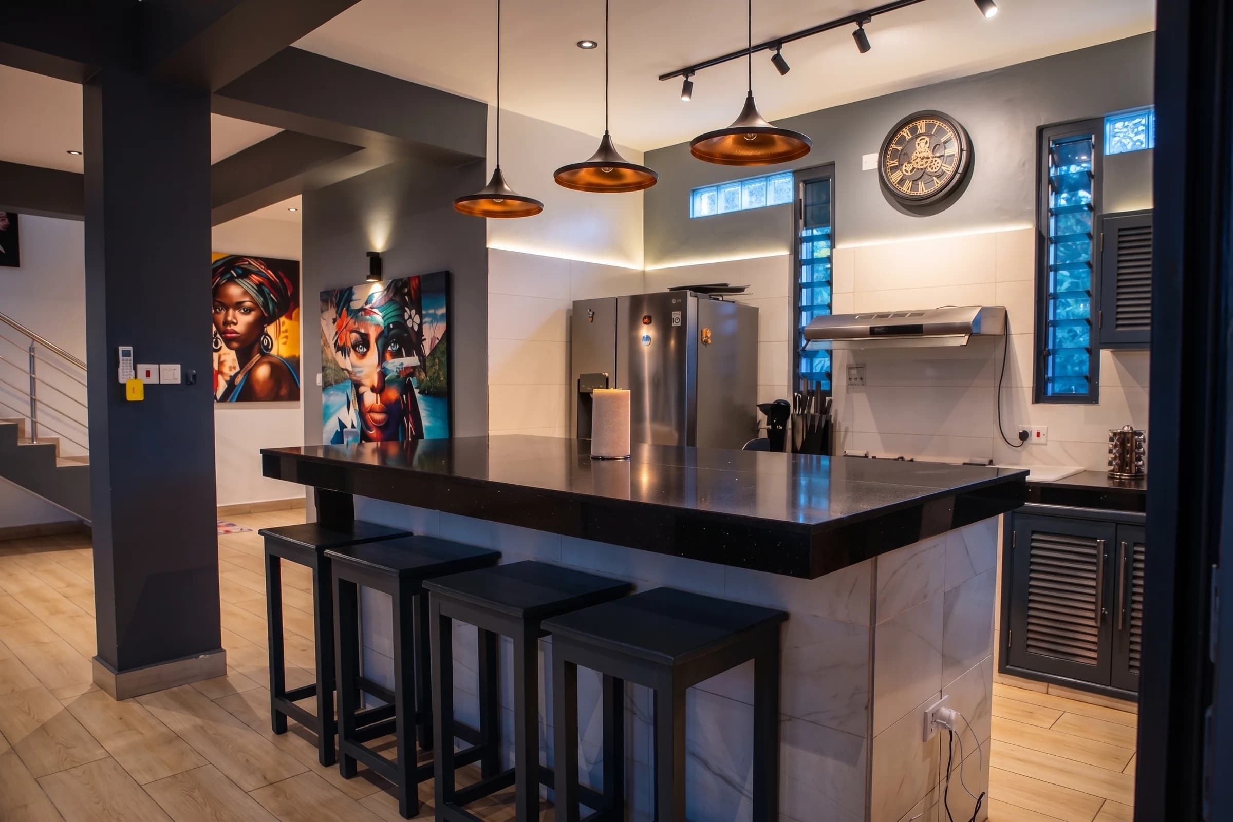 Gourmet kitchen island and breakfast bar with quartz countertops and pendant lighting