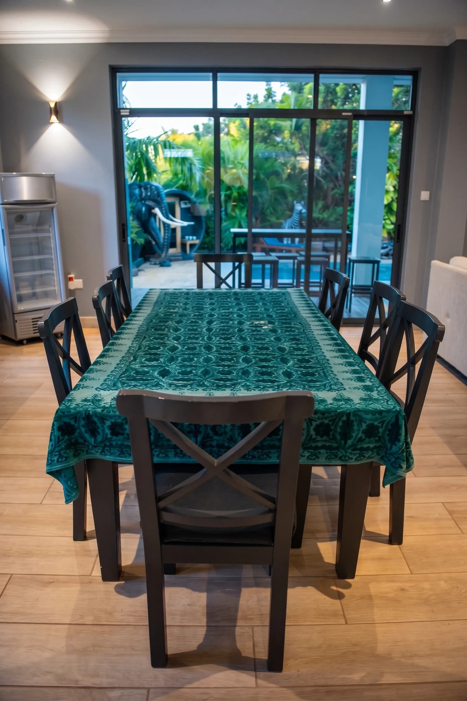 Custom-crafted Swahili 8-seater hardwood dining table with elegant ambient lighting