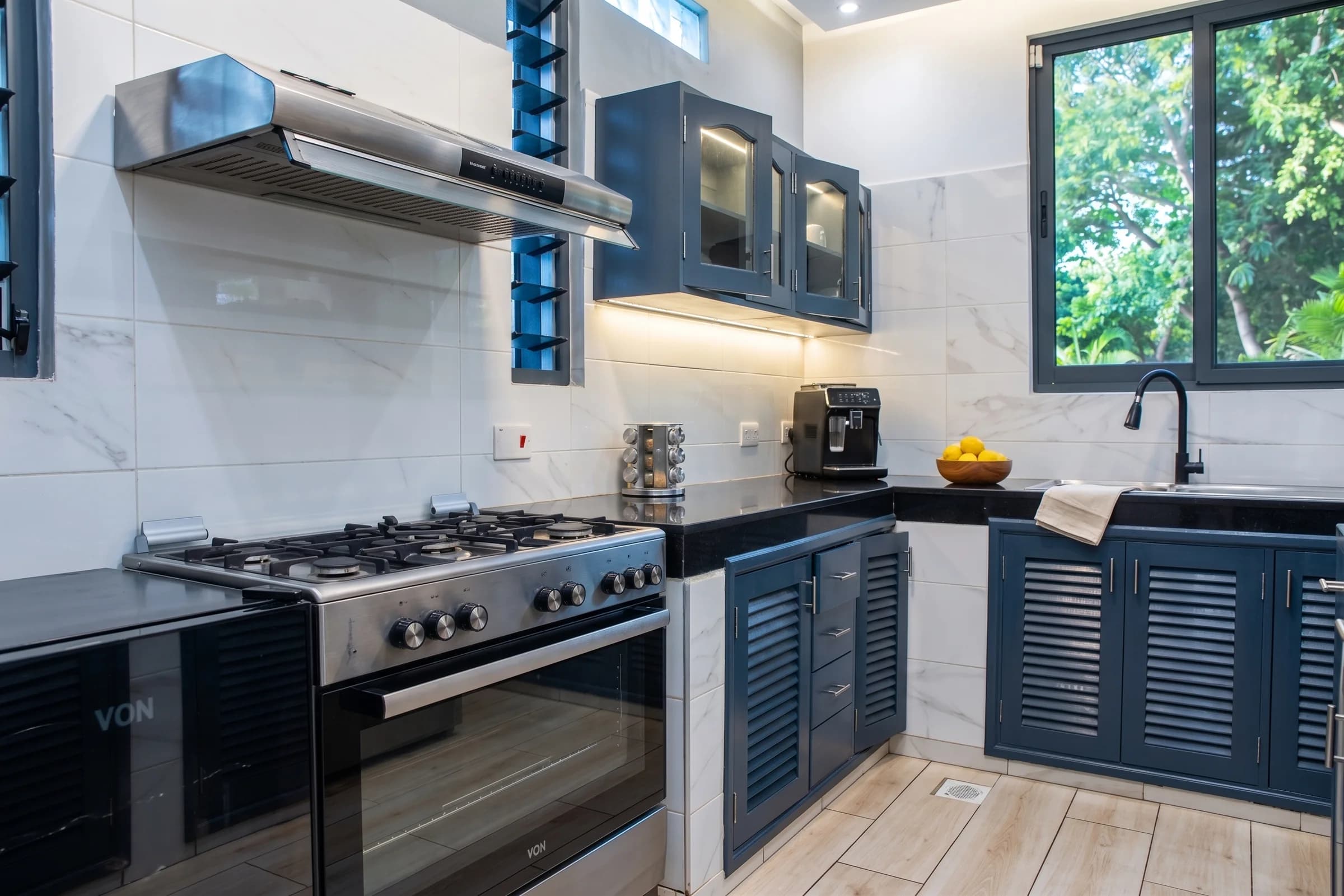 Fully equipped contemporary kitchen with premium stainless steel appliances and ample culinary workspace