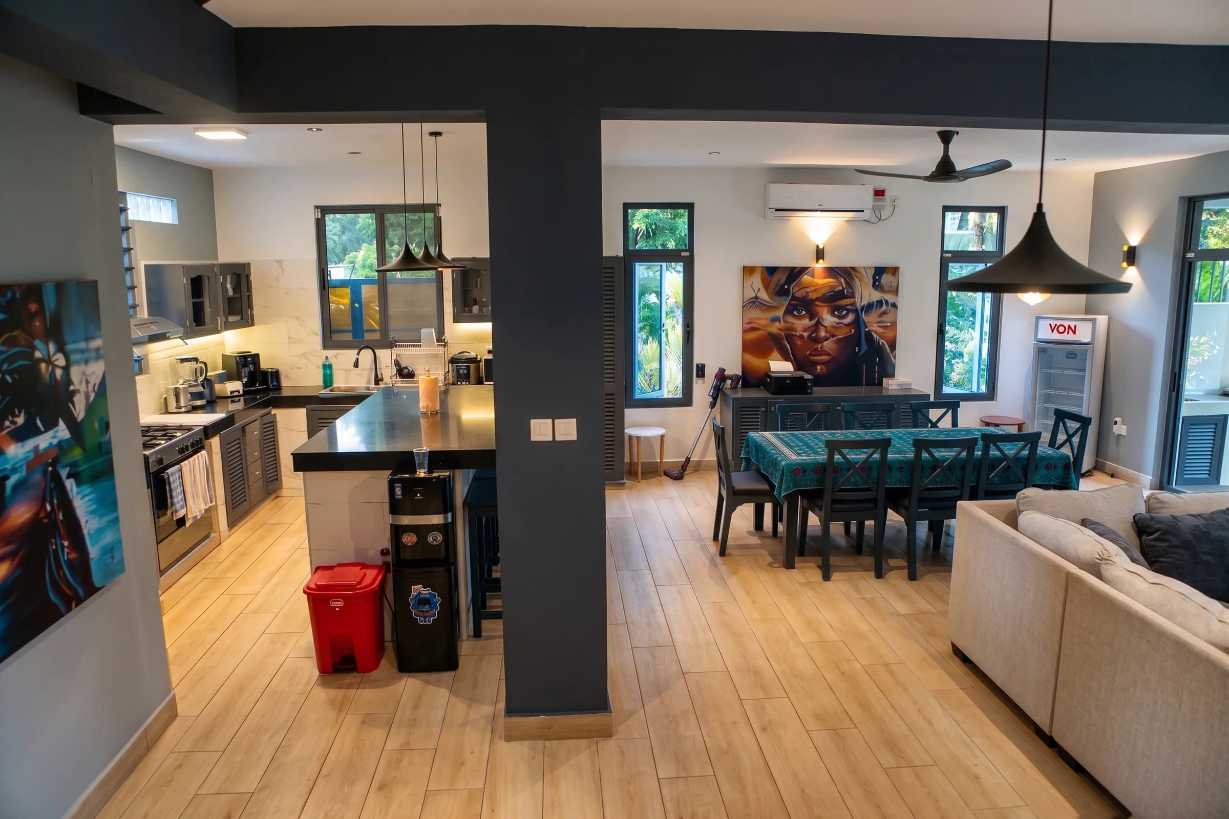 Open-plan luxury interior showing chef-grade kitchen and grand dining room in The Coastal Estate main villa