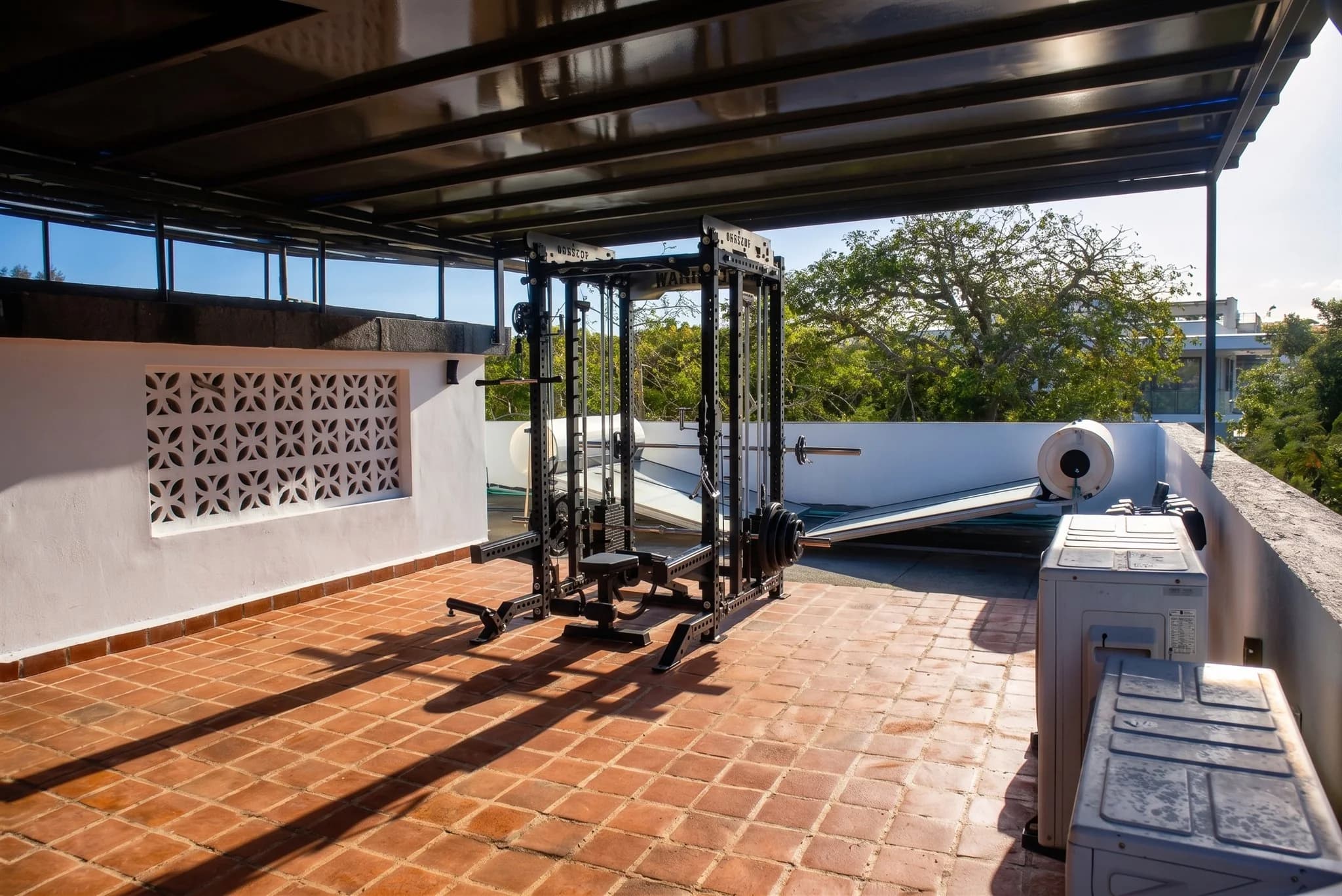 Fully equipped private open-air rooftop fitness gym catching ocean breezes at The Coastal Estate
